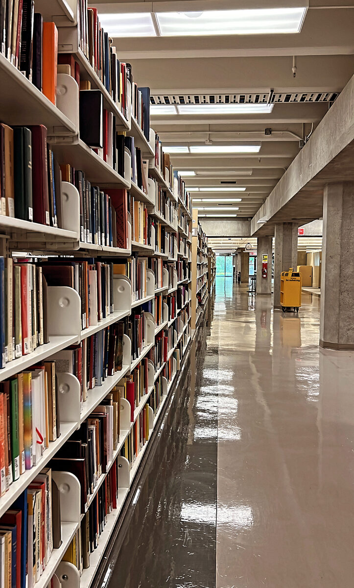 A long aisle of book stacks at Koerner Library, UBC